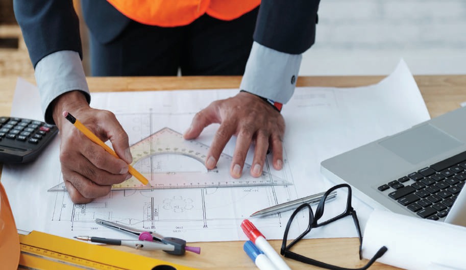 Engineer reviewing technical drawings